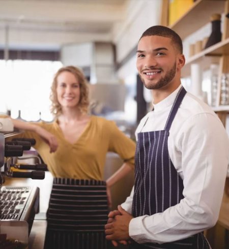 Hospitality workers standing together at a cafe counter